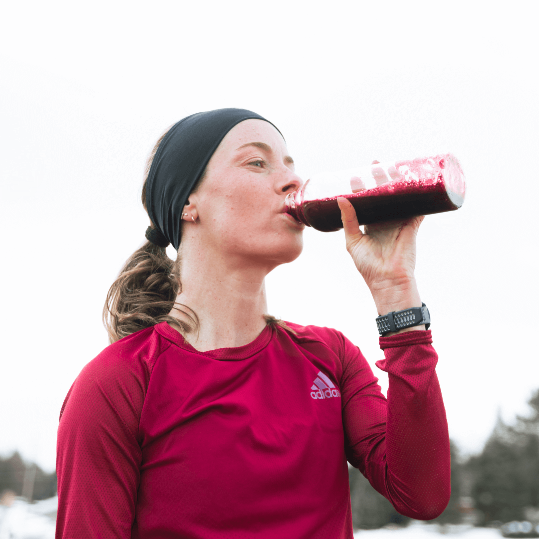 Woman runner drinks blackcurrant powder